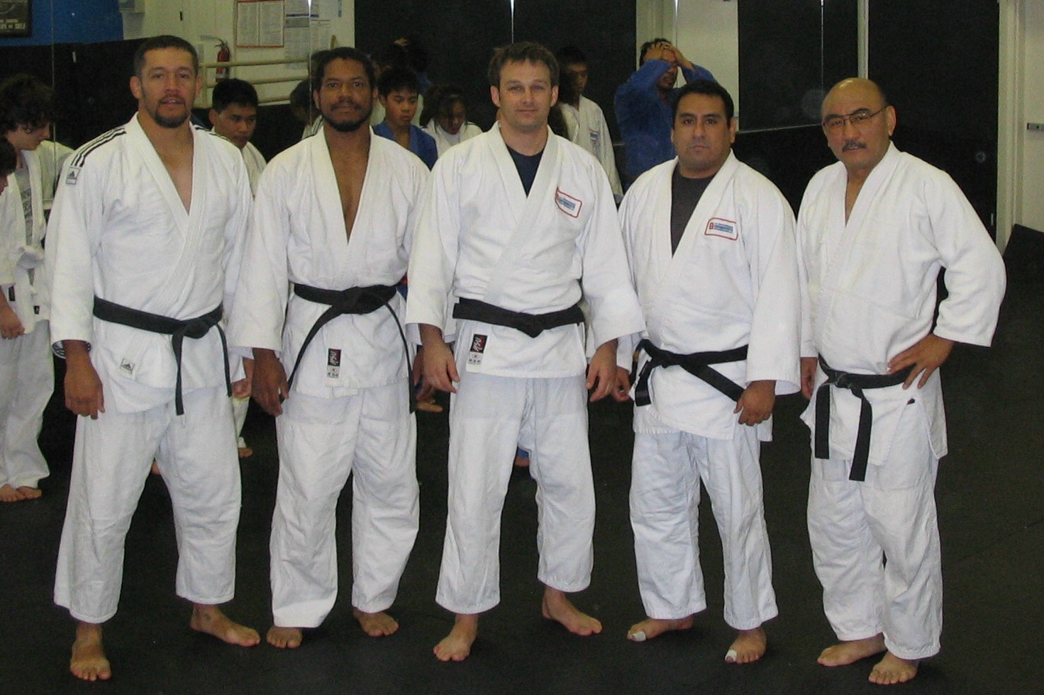 Five black belt instructors standing together in the dojo, 2007